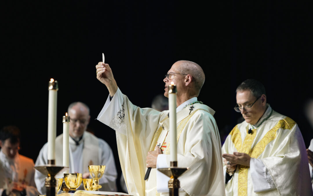 Archbishop Etienne lifts the host during the Consecration at the Mass celebrated at the ASCEND Eucharistic Revival.